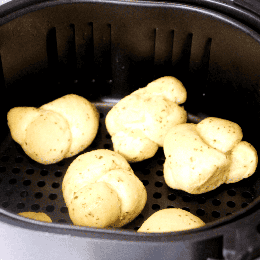 Preheat the Air Fryer: Start by preheating your air fryer to 360°F (182°C). Preheating ensures that the knots cook evenly.

Prepare the Air Fryer Basket: Lightly spray the air fryer basket with cooking spray. This helps to prevent the garlic knots from sticking to the basket.

Arrange the Garlic Knots: Place the New York Bakery Garlic Knots in the air fryer basket in a single layer, ensuring they are not touching or overcrowded. You may need to cook in batches depending on the size of your air fryer.

Air Fry: Cook the garlic knots for about 4-5 minutes, then flip them over and cook for an additional 4-5 minutes, or until they are heated through and golden brown.

Garlic Butter Sauce (Optional): While the knots are air frying, make your garlic butter sauce by melting the butter in a pan over medium heat. Add the minced garlic and cook until fragrant. Be careful not to burn the garlic.

Season and Serve: If desired, sprinkle the freshly cooked garlic knots with chopped fresh parsley and grated parmesan cheese for an extra layer of flavor. If you made the garlic butter sauce, drizzle this over the knots now. Serve warm.