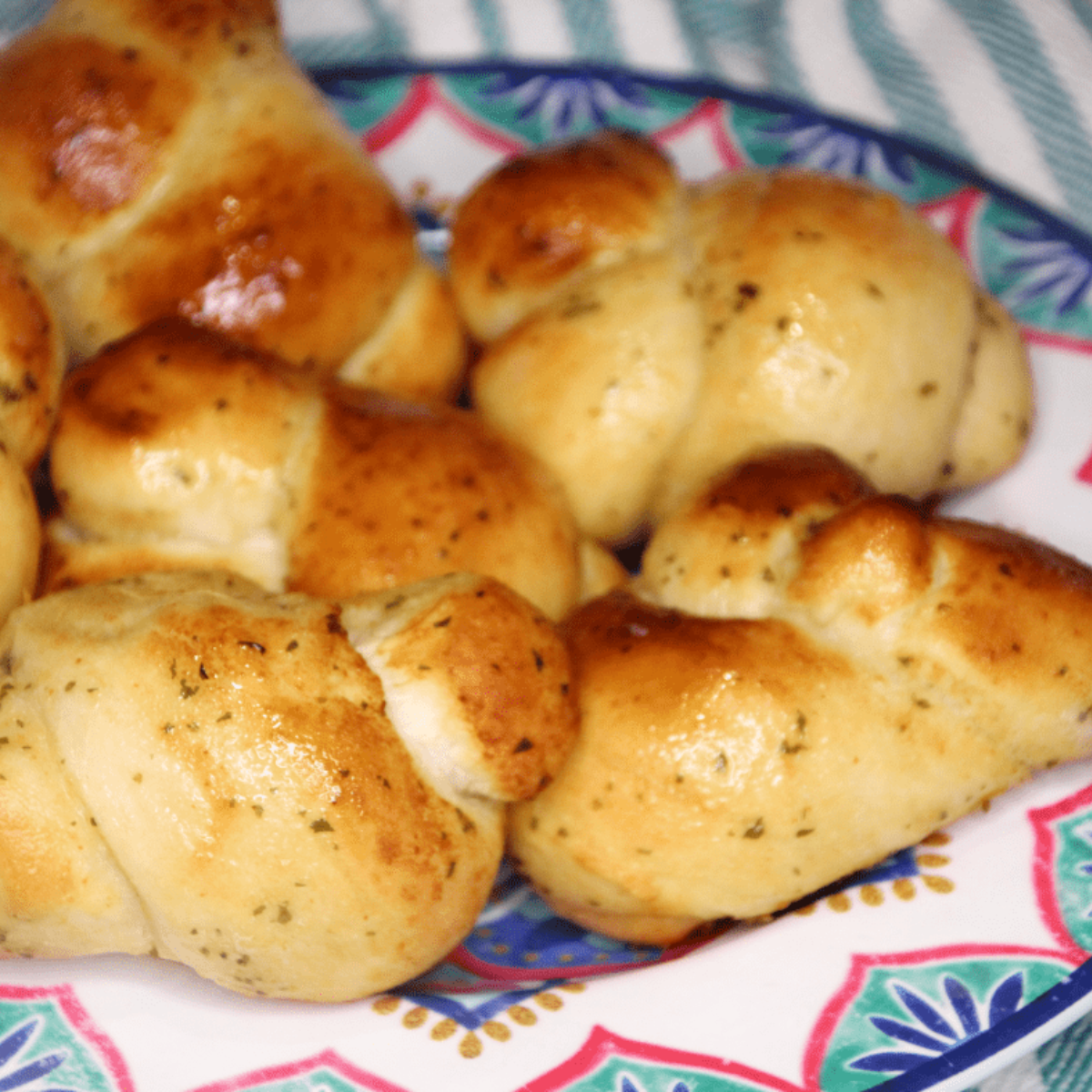 When preparing New York Bakery Garlic Knots in an Air Fryer, here are a few pro tips to ensure you get the best results:

Don't Overcrowd the Basket: This is important to ensure that the hot air can circulate properly and cook each garlic knot evenly. Overcrowding may lead to some knots being undercooked while others are overcooked.

Flip the Knots: Even though air fryers are known for their ability to cook food evenly due to the hot air circulation, flipping the knots halfway ensures a uniformly crispy and golden exterior.

Adjust Cooking Time: The cooking times mentioned in recipes are usually an estimate. Depending on your specific air fryer model, you may need to adjust cooking times slightly. Always keep a close eye on the knots during the final minutes of cooking to prevent them from burning.

Keep It Hot: For the best results, serve the garlic knots immediately after cooking while they are still hot and crispy. If you need to reheat them, popping them back in the air fryer for a minute or two can help regain some crispiness.

Experiment with Flavors: Don't be afraid to experiment with different seasonings. For example, you might want to try adding a sprinkle of chili flakes for some heat, or some grated cheddar cheese for extra richness.

Use Fresh Ingredients for Garnishing: If you're adding a garnish, try to use fresh ingredients. Freshly chopped parsley or freshly grated parmesan cheese can make a big difference in flavor compared to dried or pre-packaged versions.

Make a Dipping Sauce: While these garlic knots are delicious on their own, consider serving them with a side of marinara sauce for dipping. It complements the rich garlic and butter flavors beautifully.