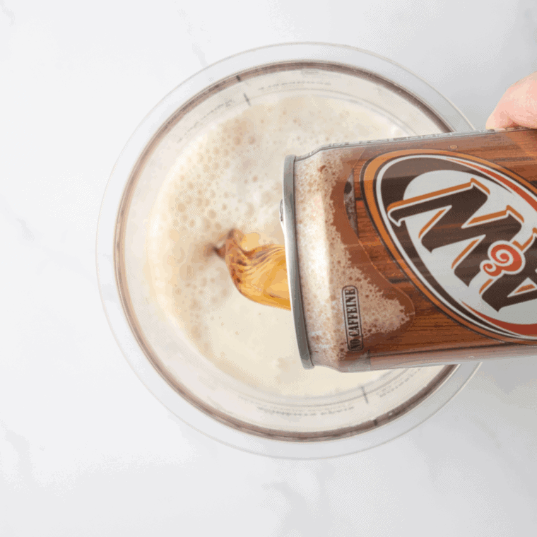 Dr Pepper cream soda poured into Ninja Creami pint container before freezing for 24 hours