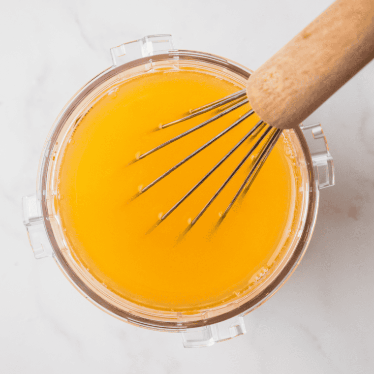 Clear dissolved sugar syrup in a measuring cup, the base for Ninja Creami lemon sorbet