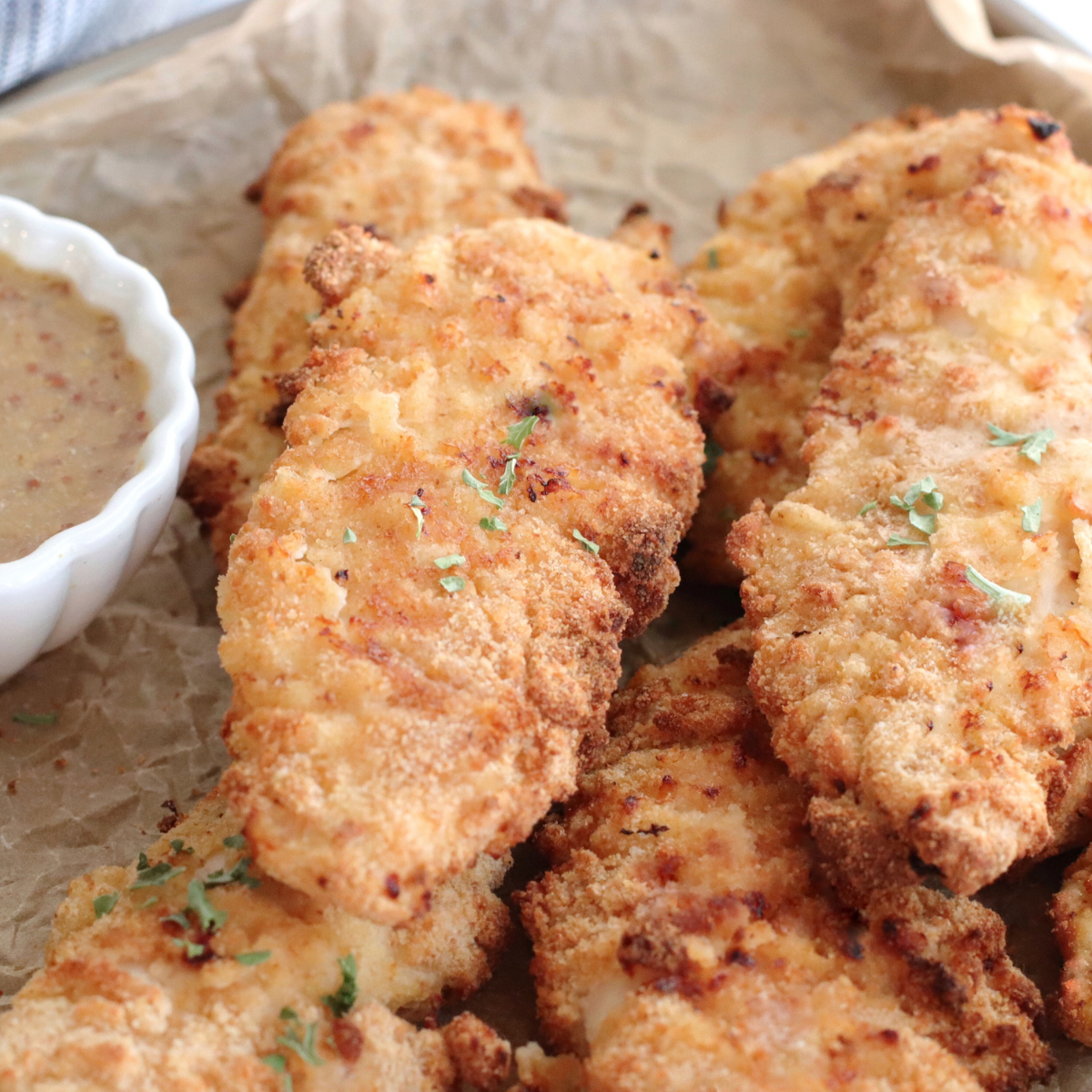 To make the most delicious and perfectly cooked chicken tenders on the Ninja Foodi Grill, here are some pro tips: Use panko breadcrumbs: For an extra crispy coating, consider using panko breadcrumbs instead of regular breadcrumbs. Panko breadcrumbs have a lighter and crispier texture, resulting in a more satisfying crunch. Season the breadcrumbs: Enhance the flavor of your chicken tenders by adding additional seasonings to the breadcrumb mixture. Try mixing in garlic powder, onion powder, paprika, or your favorite herbs and spices to give the tenders a tasty kick. Preheat the grill properly: Ensure that the Ninja Foodi Grill is fully preheated before placing the chicken tenders on the grates. This helps to sear the outside quickly, sealing in the moisture and creating a nice crust. Oil the grill grates: Prevent the chicken tenders from sticking by lightly oiling the grill grates before placing the chicken on them. You can use a brush or a paper towel to apply a thin layer of oil. Use an instant-read thermometer: To ensure the chicken tenders are cooked to perfection, use an instant-read thermometer to check the internal temperature. The chicken should reach 165°F (74°C) for safe consumption. Avoid overcooking to maintain juiciness. Don't overcrowd the grill: Give each chicken tender enough space on the grill grates to ensure even cooking. Overcrowding can lead to uneven heat distribution and result in less crispy tenders. Flip with care: When flipping the chicken tenders, use tongs or a spatula to gently turn them over. Be cautious not to disturb the coating to maintain the crispy texture. Experiment with different marinades: Before coating the chicken tenders with breadcrumbs, consider marinating them in your favorite marinade for added flavor. Teriyaki, barbecue, or honey mustard marinades can infuse the chicken with a delicious taste. Let them rest: After grilling, allow the chicken tenders to rest for a few minutes before serving. This helps the juices redistribute, resulting in more flavorful and moist chicken. Serve with dipping sauces: Elevate your chicken tenders by serving them with an array of dipping sauces. From classic ketchup and mustard to creamy ranch or tangy buffalo sauce, the options are endless. By following these pro tips, you'll be able to create incredibly delicious and perfectly cooked chicken tenders on your Ninja Foodi Grill. Enjoy the crispy exterior, juicy interior, and burst of flavors with every bite!