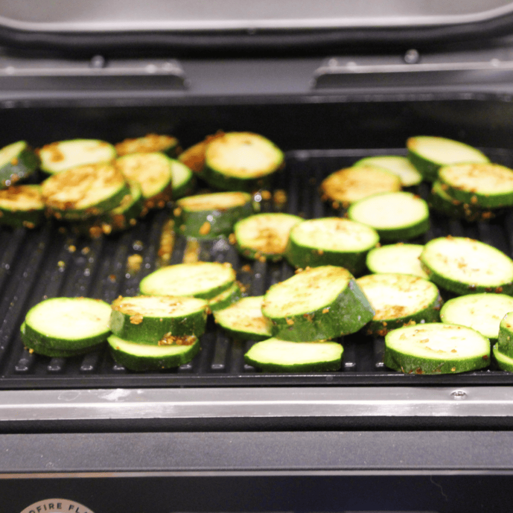 Preheat your Ninja Foodi Grill by selecting the GRILL setting and setting the temperature to medium.

While the grill is preheating, wash the zucchinis and cut off the ends. Slice the zucchinis lengthwise into 1/4 inch thick strips.

Brush the zucchini slices with olive oil on both sides. Then sprinkle with salt, pepper, and any additional herbs or spices if you're using them.

Once the grill is preheated, arrange the zucchini slices on the grill plate. Close the grill and let the zucchini cook for about 3-4 minutes.

Open the grill and flip the zucchini slices over. Close the grill again and let the other side cook for another 3-4 minutes.

Check the zucchini for doneness. The slices should be tender and have nice grill marks. If they're not done to your liking, you can continue grilling for another 1-2 minutes.

Once the zucchini is done, carefully remove it from the grill using a spatula. If desired, sprinkle with grated Parmesan cheese while the zucchini is still hot.

Let the grilled zucchini cool for a few minutes before serving. Enjoy!