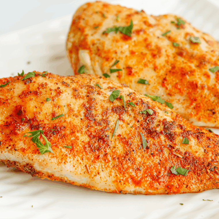Juicy air fryer buffalo shredded chicken in a bowl, coated in spicy buffalo sauce, ready for wraps, salads, or sandwiches.