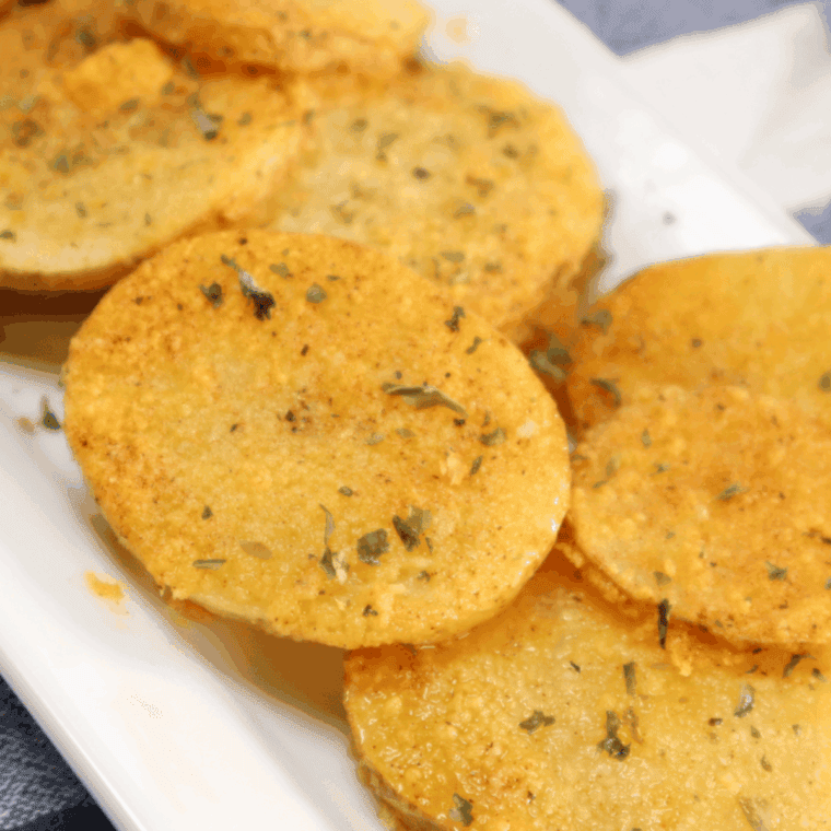 A plate of crispy, golden Air Fryer Cottage Fries, served with a dipping sauce.