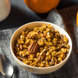 Pumpkin Spice Granola in a white bowl on a table