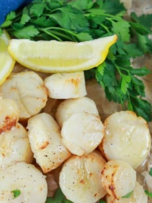 Scallops sizzling on a hot Blackstone griddle with butter and garlic