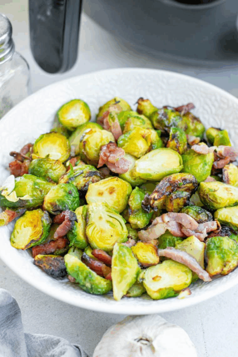 Crispy and caramelized Copycat Bonefish Grill Brussels Sprouts served in a white dish, garnished and ready to eat.