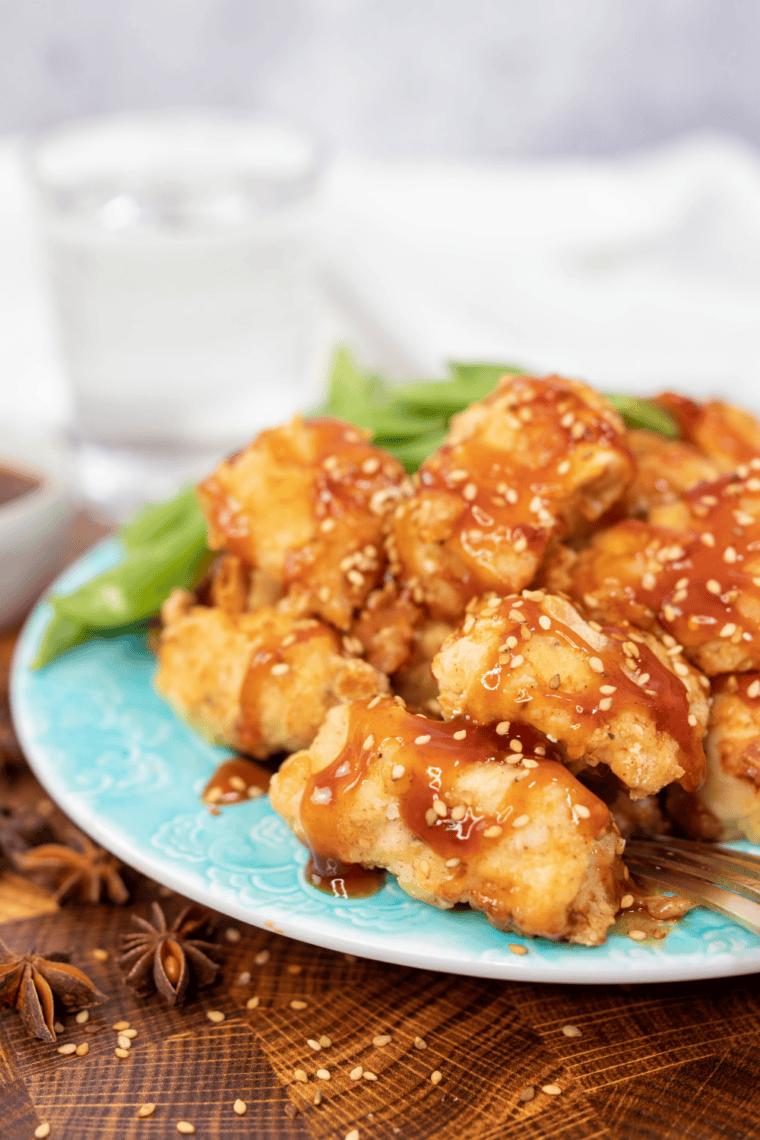 Bowl of homemade McDonald's Sweet 'N Sour Sauce with a chicken nugget being dipped in.