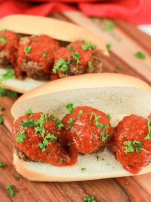 Copycat Subway meatball sub on a wooden board with melted mozzarella and marinara