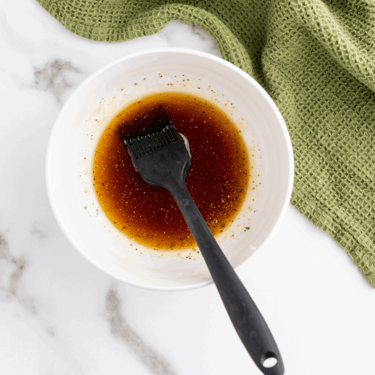 Small bowl of brown sugar, melted butter, and optional ingredients being mixed.