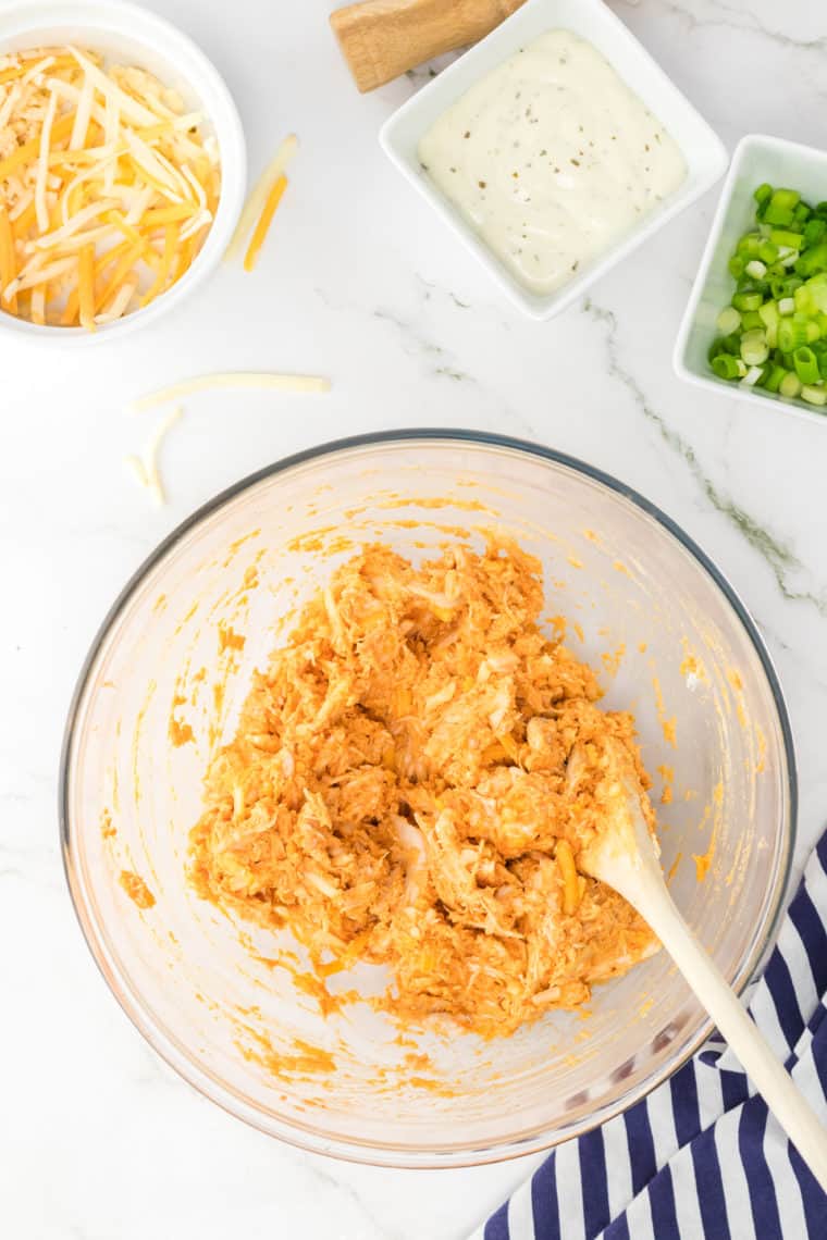 Achieving that perfect balance of spice, moisture, and texture in your Air Fryer Shredded Buffalo Chicken can be a breeze with these pro tips:

Quality Chicken: Always start with fresh, high-quality chicken. The breast is the most popular choice due to its lean texture, but thighs can yield a juicier result. Make sure your chicken is defrosted thoroughly if you're using frozen pieces.

Marinate for Flavor: While a quick toss in seasonings is okay, allowing the chicken to marinate for a few hours (or even overnight) will infuse it with more depth of flavor.

Avoid Overcrowding: Ensure the chicken pieces don’t touch each other in the air fryer. Overcrowding can cause uneven cooking and prevent the chicken from getting that desired crispy exterior.

Temperature Check: Invest in a good meat thermometer. Chicken should always be cooked to an internal temperature of 165°F (74°C) for safety. This ensures you have perfectly cooked chicken that’s juicy but not overdone.

The Right Buffalo Sauce: Not all Buffalo sauces are created equal. Go for a trusted brand that offers the right blend of spice and tanginess for your palate.

Add Butter: Consider mixing a bit of melted butter into your Buffalo sauce before tossing with the shredded chicken. It adds richness and helps cut some of the sharpness of the hot sauce.

Shred While Warm: Chicken is easiest to shred when it’s fresh out of the air fryer and still warm. Using two forks works well, or for larger quantities, you can use a stand mixer with the paddle attachment.

Reheating: If you have leftovers, the air fryer is perfect for reheating! A few minutes at a lower temperature (around 300°F or 150°C) can revive the crispy texture and warmth of the chicken without drying it out.

Versatility: Shredded Buffalo chicken can be used in a variety of dishes - from sandwiches and wraps to pizzas and salads. Consider making a bigger batch for multiple meals throughout the week.

Personalize: Everyone's heat tolerance is different. Don’t hesitate to adjust the amount of Buffalo sauce to your liking. You can also add ingredients like honey or brown sugar if you prefer a sweeter heat.

Remember, the beauty of cooking at home is the ability to customize dishes to your liking. Don’t be afraid to experiment a bit with your Air Fryer Shredded Buffalo Chicken to find your perfect blend of flavors and textures. Enjoy!