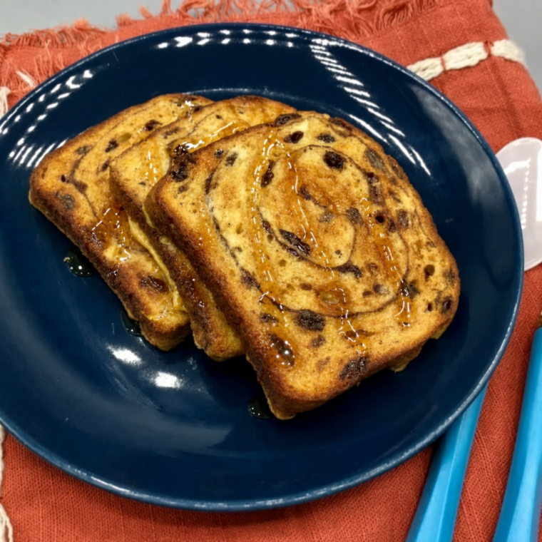 Stack of golden French toast slices on a white plate