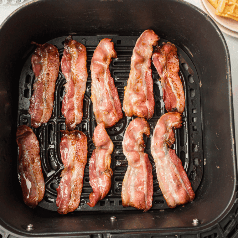 Crispy Bar-S bacon slices cooked in an air fryer basket, ready to serve.