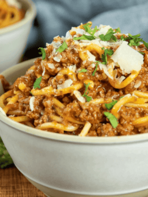 Bowl of spaghetti and meatballs made in Ninja Speedi with rich tomato sauce and parmesan