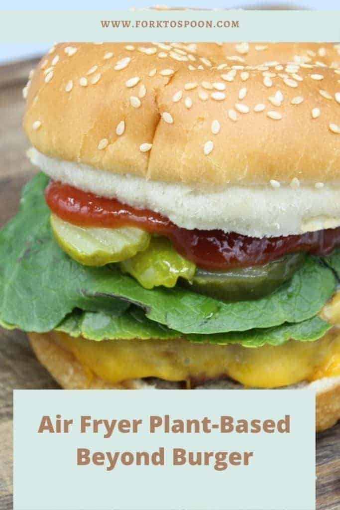 Close up of an air fryer beyond burger with overlay text reading "Air Fryer Plant-Based Beyond Burger"