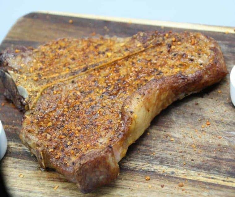 Close up of a cooked porterhouse steak that was made in an air fryer. 