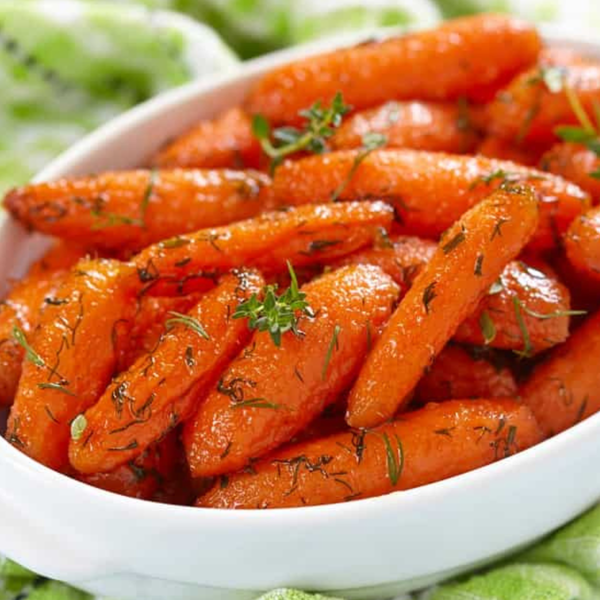 Air Fryer Baby Carrots cooked to a tender, vibrant finish, garnished with fresh herbs.