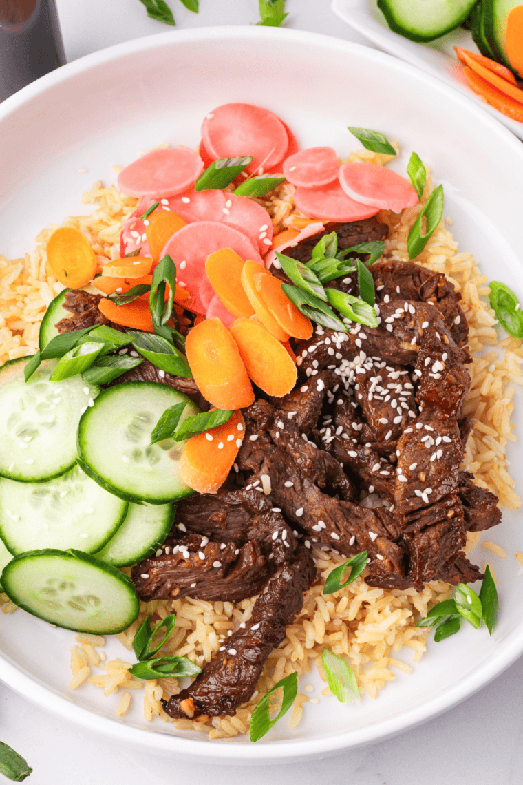 Air Fryer Trader Joe's Bool Kogi served over white rice with saut&eacute;ed vegetables