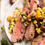 Sliced Blackstone flank steak with grill marks on a flat top griddle