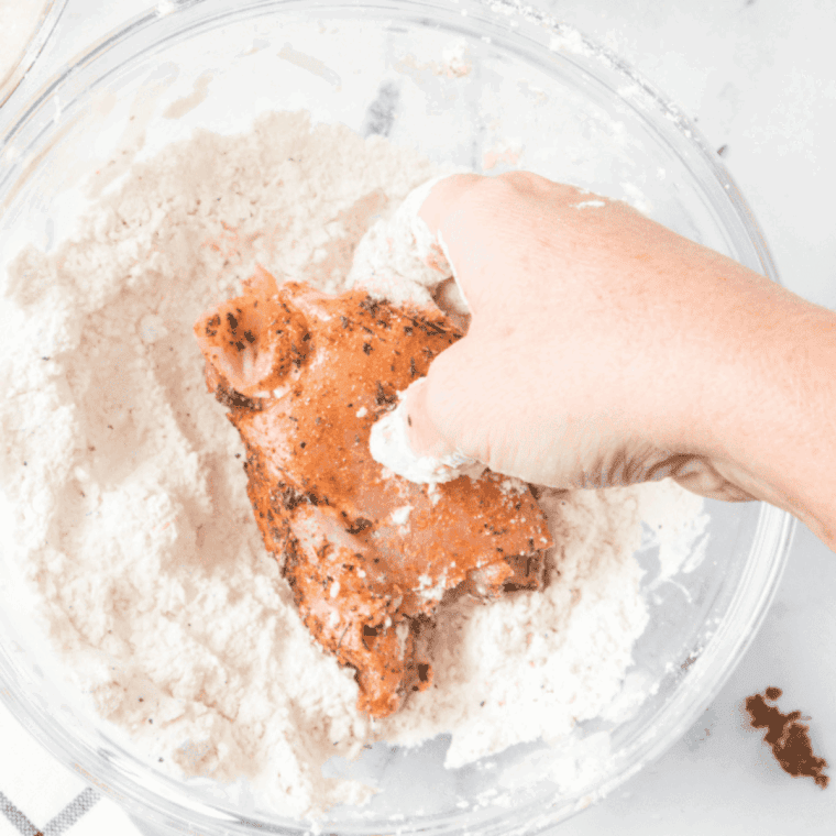 Toss the chicken into the flour coating.
