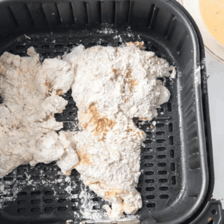Coated Bob Evan’s Fried Chicken in the air fryer basket.