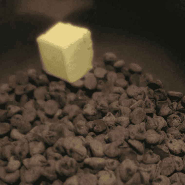 Semi-sweet and milk chocolate chips melting with sweetened condensed milk and butter in a saucepan