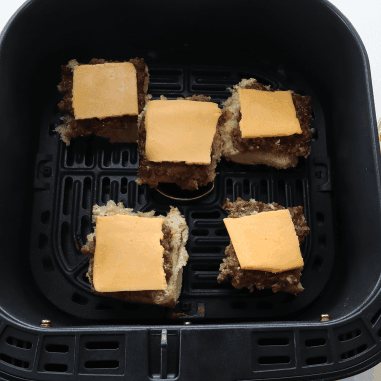 Melting cheese on slider patties and toasting buttered buns in the air fryer until golden.