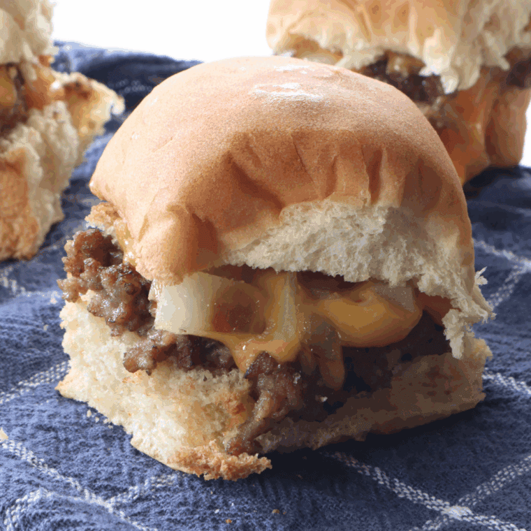 Air fryer White Castle-style sliders with thin beef patties, soft buns, and diced onions.