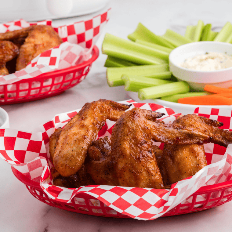 Saucy chicken wings tossed in homemade Hooters wing sauce, garnished and served