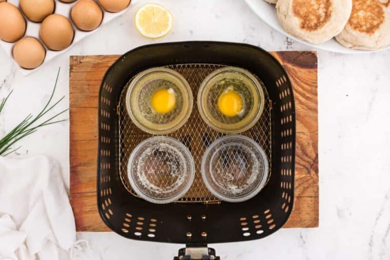 top view of air fryer poached eggs in the air fryer basket. 