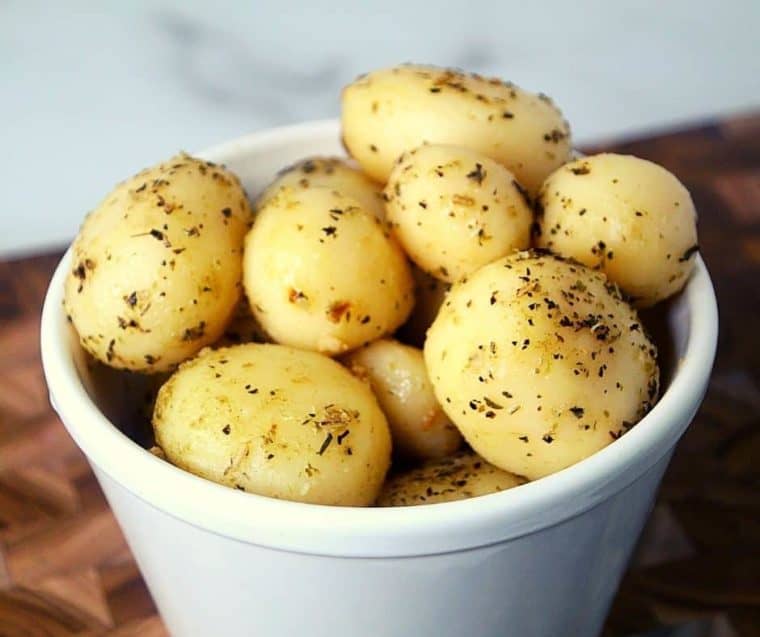 Finished air fried canned potatoes recipe in a white serving bowl. 