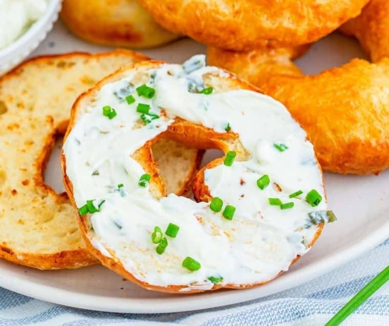 Close up of 2 ingredient bagels  topped with cream cheese and chives 