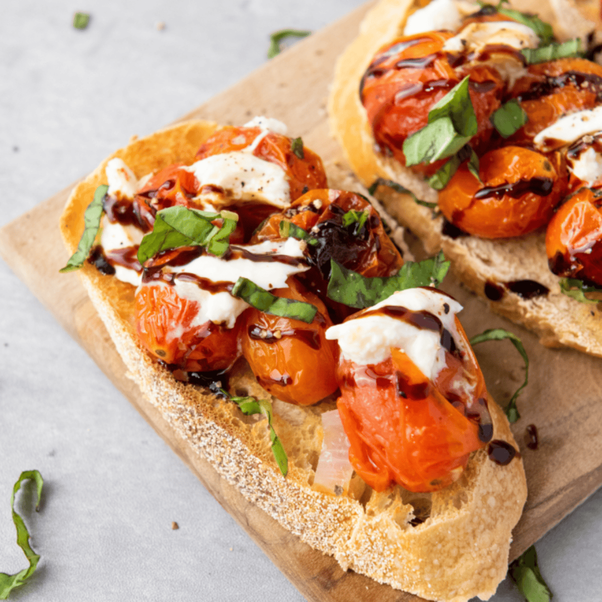 Plate of tomato covered bread toasted.