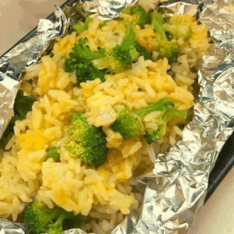 Plate of broccoli and rice on kitchen table.