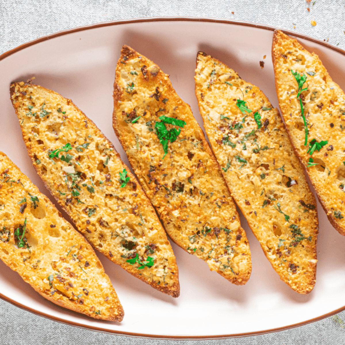 Garlic bread slices toasted to golden brown