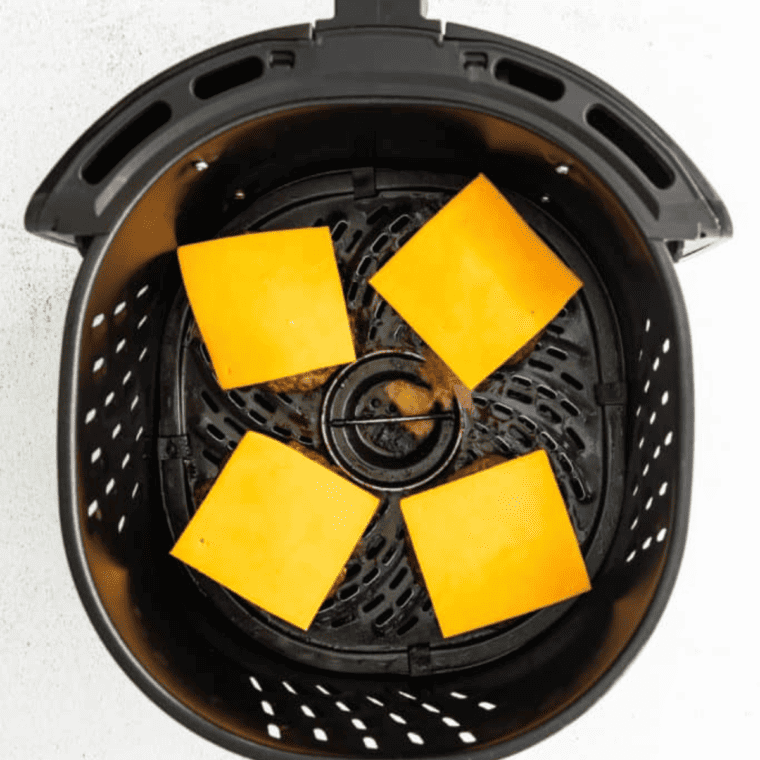 Air Fry the Patties: Place the burger patties in the preheated air fryer basket. Cook for about 5 minutes on one side.