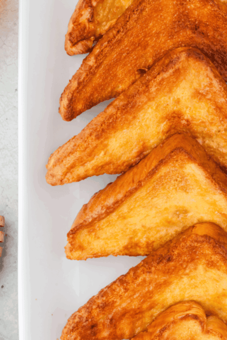 Golden air fryer honey toast with melted butter and honey drizzle on a plate.