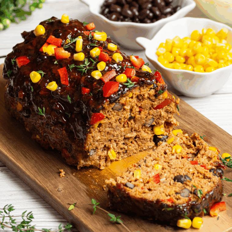 Juicy reheated meatloaf slice in air fryer basket with golden edges.