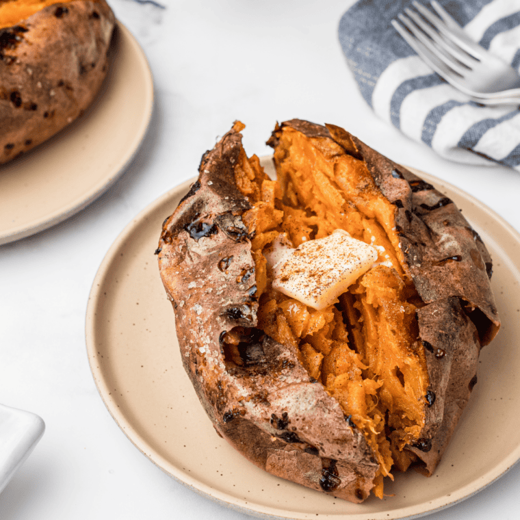 Outback Steakhouse sweet potato split open with honey cinnamon butter and brown sugar melting inside