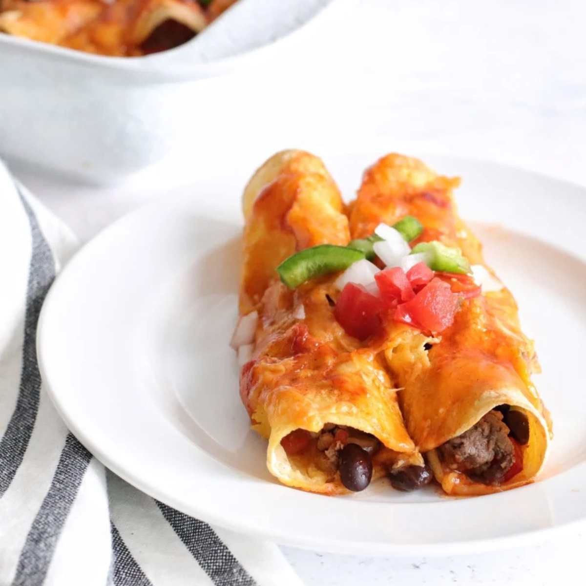 Delicious reheated enchiladas plated and ready to enjoy.