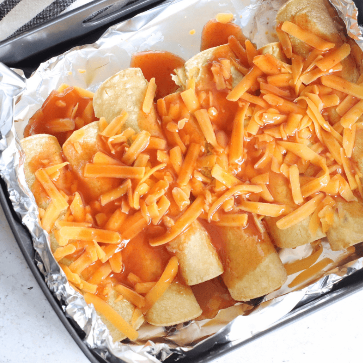 Close-up of reheated enchiladas in an air fryer, ready to serve.