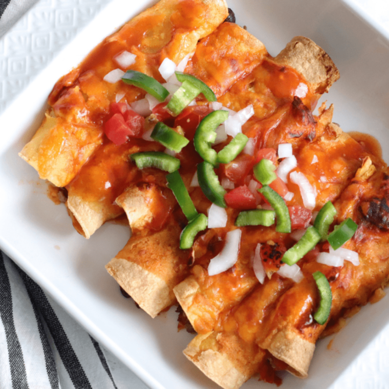 Close-up of reheated enchiladas in an air fryer, ready to serve.