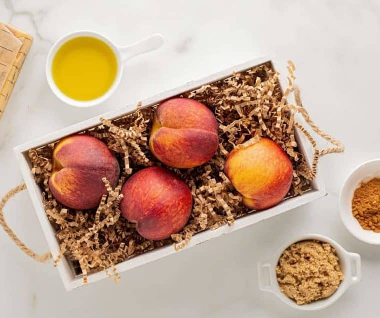 Top view of peaches in a basket to depict before you air fry peaches 