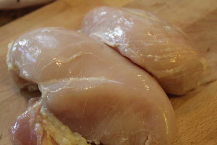 boneless skinless chicken breasts on cutting board