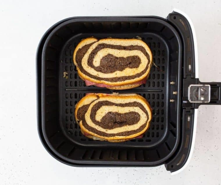 Top view of a reuben sandwich in air fryer basket. 