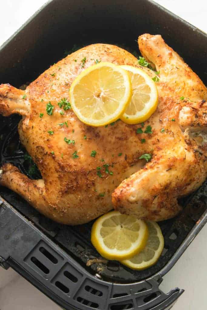 lemon and herb whole chicken in air fryer basket