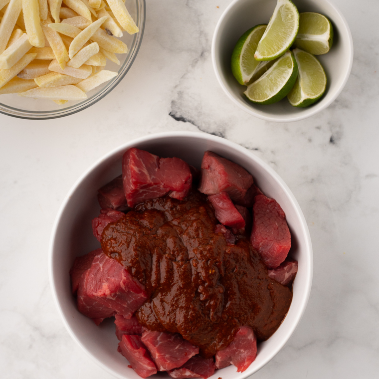 Preheating the air fryer to 375°F for 3-5 minutes and adding the coated beef chunks into the air fryer basket in a single layer, cooking for 8-10 minutes.