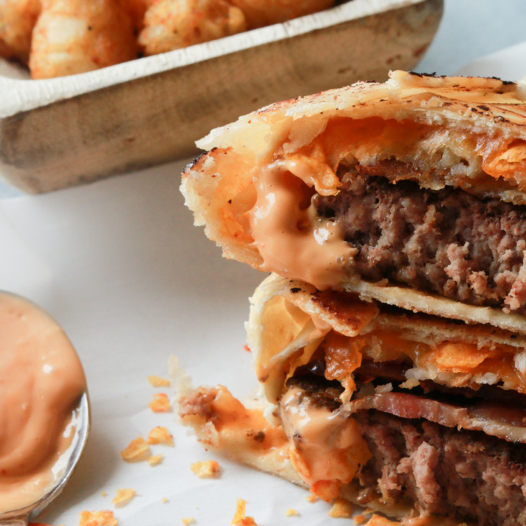 Air Fryer Cheeseburger Crunch Wrap with beef patty, cheese, bacon, tater tots, and Doritos wrapped in a flour tortilla, air fried to golden perfection.