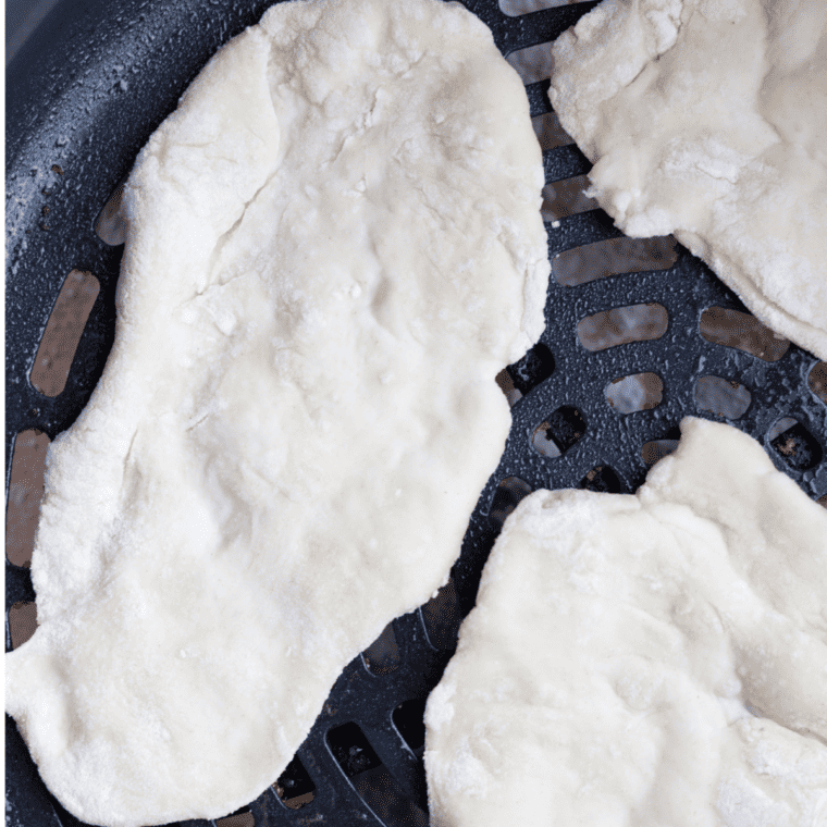 Preheating air fryer and cooking rolled dough to golden, puffed perfection; flipping for even cooking.