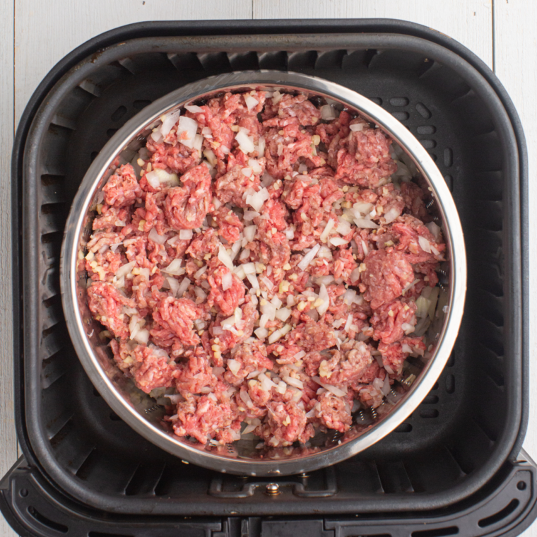 Place seasoned Korean beef into the air fryer basket.